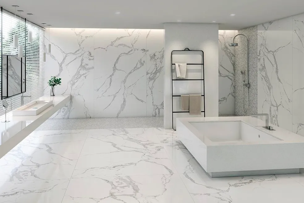 A bathroom with white marble walls and floors.