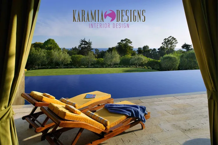 A pool with two lounge chairs and a blue umbrella.