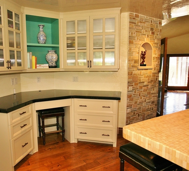 A traditional style kitchen design with a functional desk area.