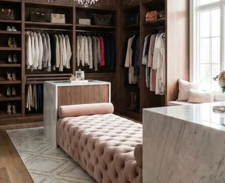Boutique-style walk-in closet with display shelving and warm lighting in Los Angeles home