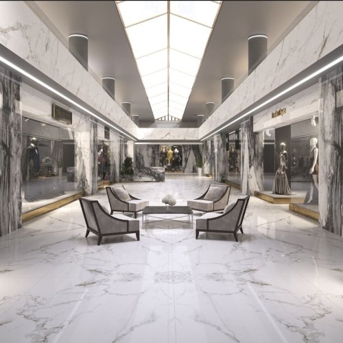 Intriguing boutique shops in a bustling mall, designed with elegance and sophistication. The interior showcases the use of book-matched large SinteClad porcelain slabs, creating a mesmerizing visual effect.