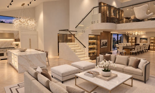 This Porter Ranch estate by Karamia Designs brings the living room, kitchen, and dining area together through soft ivory tones, subtle stone textures, and brushed gold accents. A glass-railed staircase and sparkling chandeliers provide architectural drama, while layered seating and warm lighting create a welcoming luxury interior for gathering and entertaining.