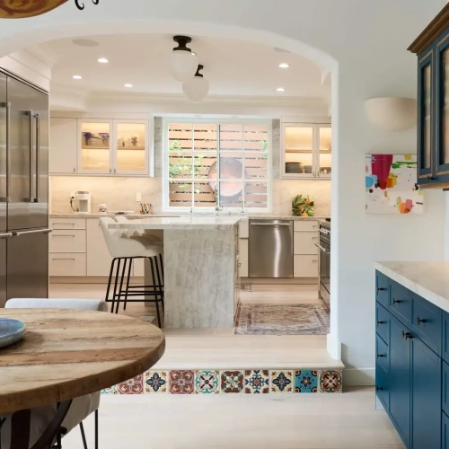Westwood kitchen and dining area with Taj Mahal stone, ILVE range, and Spanish tile staircase | Karamia Designs
